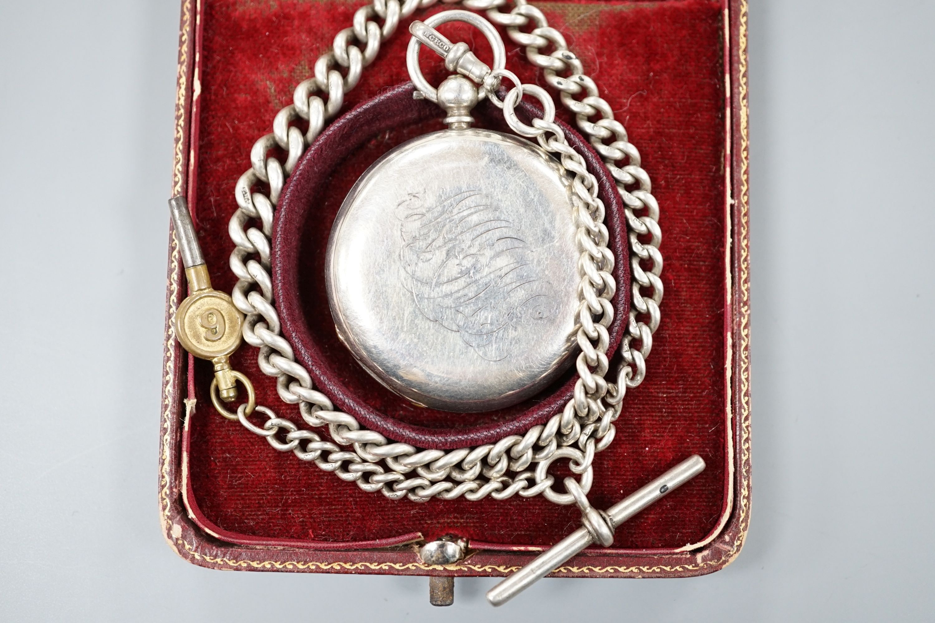 A 925 half hunter keywind pocket watch, cased diameter 46mm, on a silver albert with watch key.